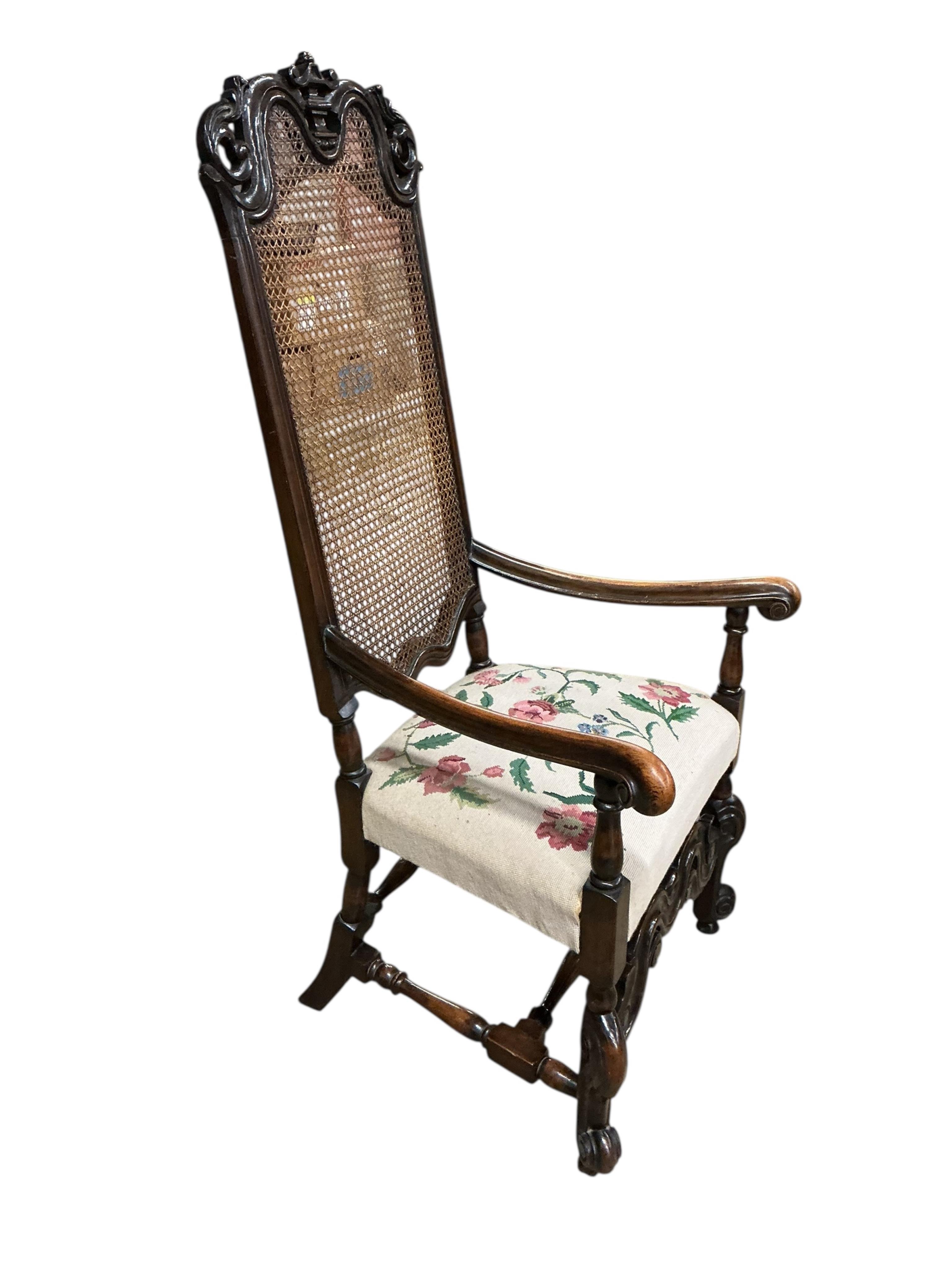 A Carolean style caned walnut high back elbow chair, width 65cm, depth 58cm, height 140cm